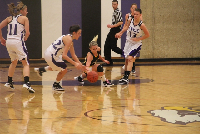 Julie Haye (22) and Whitney Hoover (4) dive for a loose ball in a game between IVCC and Black Hawk College. Imminent collision