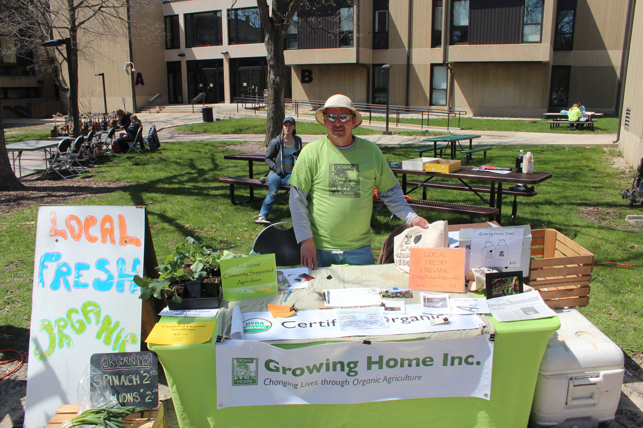Mark Parisot in front of “Growing Home Inc.” banner Growing Home
