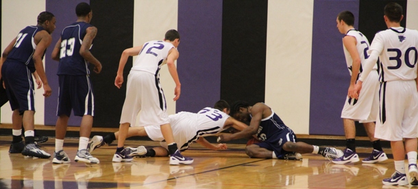 Josh Fenoglia (33) dives after a loose ball against South Suburban College on Jan. 7. Loose ball