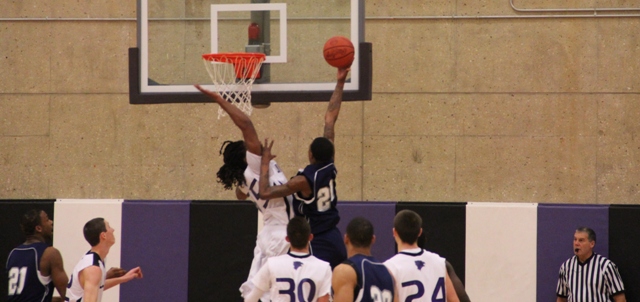 Johnathan Smith (35) tries to stop a lay-up by South Suburban's Kadeem Thorton on Jan. 7. Too late