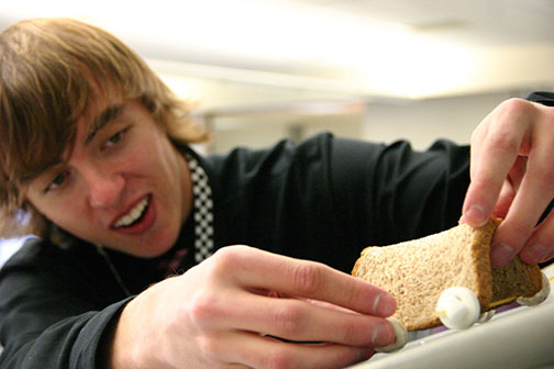 Logan Koepke makes final preparations to his makeshift car before sending it down the track at the Edible Car Contest on Feb. 20.