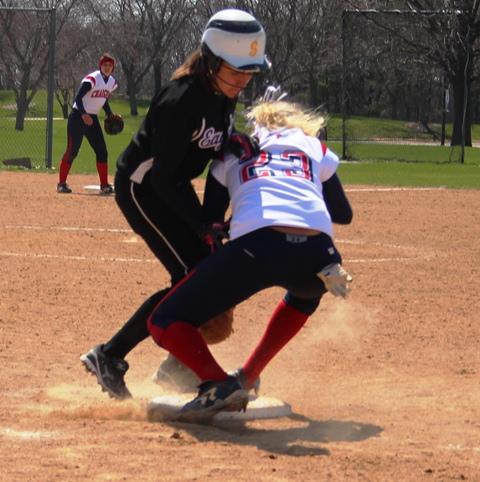 IVCC’s Katie Huss (left) makes contact with Augusta Chandler (23) during the seventh inning of a game against Carl Sandburg College on April 21. Huss was ruled to be safe on the play after the ball was knocked away from Chandler. The momentum of this play allowed IVCC to tie the game and force extra innings, although eventually the Lady Eagles fell to the Lady Chargers 7-5.