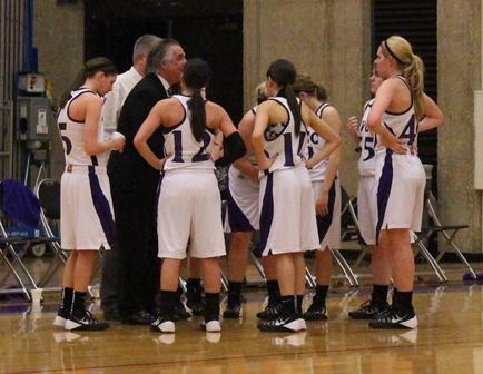 The Lady Eagles gather around first-year coach Tom Ptak during a timeout
in the team’s 78-72 victory on Jan. 16 over Carl Sandburg College.