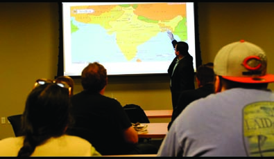 Abhijeet Bhattacharya gives a demonstration to the students participating in his Cultures of India presentation.