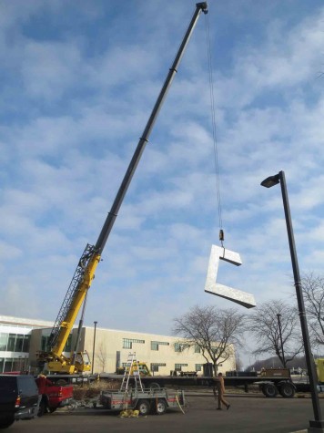 A crane lifts the final piece of the sundial sculpture, which fit together much like a puzzle, on Dec. 19. The artwork was shipped in separate parts to ensure for safer transportation.