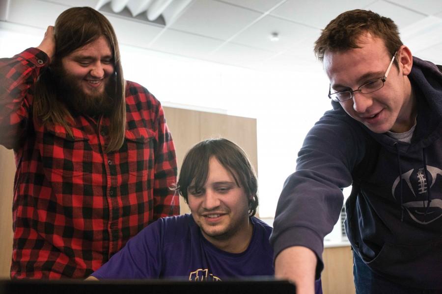 Students James Berry-Smith (left), Luke Lowers, and Anthony Mikelson look over software in a computer class, taught by Gina Elias.