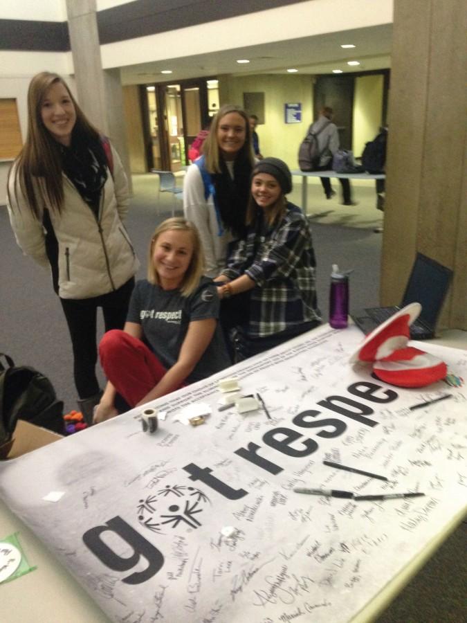 Ashley Daley (left), Brianna Bertolino, Bianca Sutton, and Samantha Halm pose by the “Got Respect” poster in the lobby to “spread the word to end the word” about using the “R” word in reference to the metally disabled.