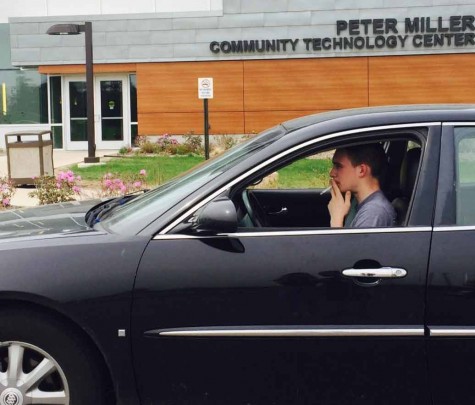 Sean Young visits IVCC on a trip from DeKalb to visit friends, posing for a picture outside the Peter Miller Community Technology Center. Once the smoking law goes into effect on July 1, cigarette use in personal vehicles will continue to be allowed.