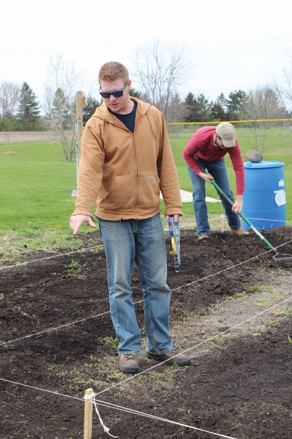 Jared Olesen, IVSustainability adviser, directs students on the plot of land designated to serve as a fully functional garden, located on the south side of campus. Olesen is currently looking for more students to dedicate time this summer to work on the garden.