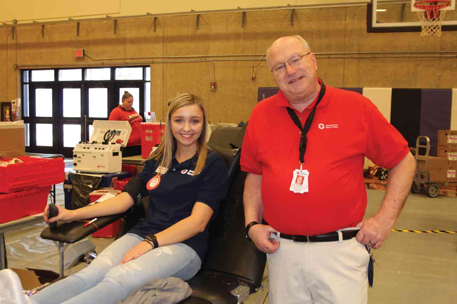 Steve Swett (right) stops to talk to a volunteer at the American Red Cross Bloodmobile in the IVCC gym.
