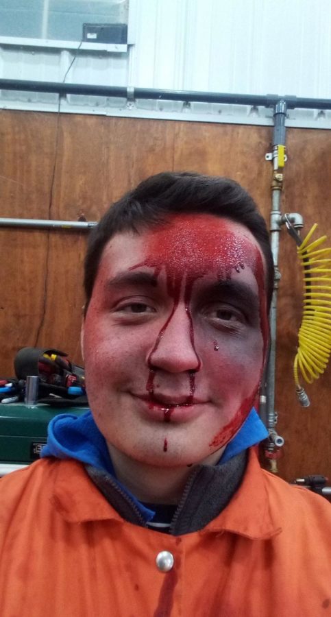 Ryan wearing a costume for a haunted house, covered in fake blood