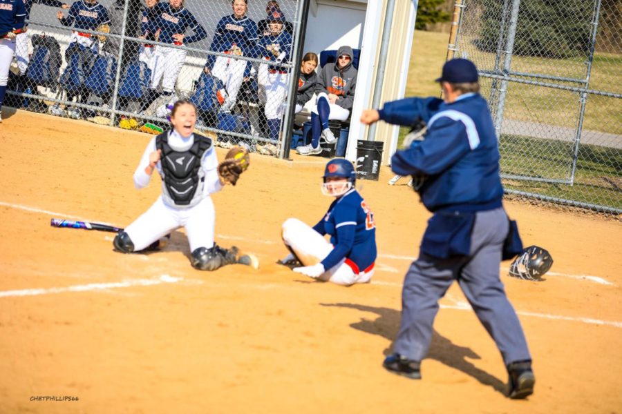 Eagles catcher Ella Sibert celebrates as the umpire calls a Highland Cougars runner out at the plate. The Eagles split a double-header with their conference foe on March 28. The Streator Woodland product boasts a .486 batting average for the Eagles.