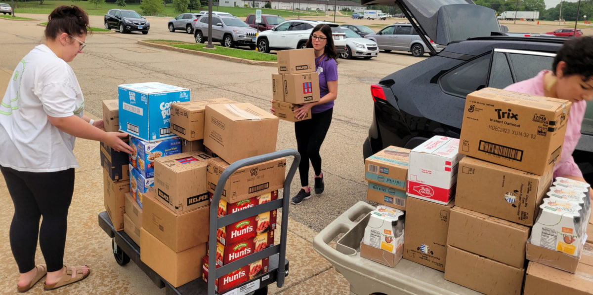 Volunteers unload items to stock the Eagles Peak food pantry, located in CTC-202R.