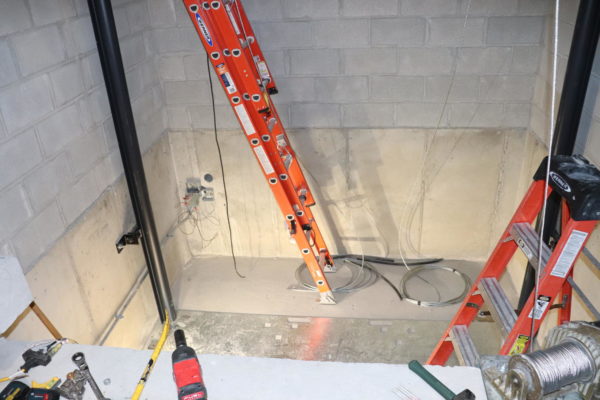 Construction workers start installing the elevator located in D-201.