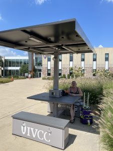 Gina Stayton of Mendota enjoys the new seating outside the main building while waiting for her ride.