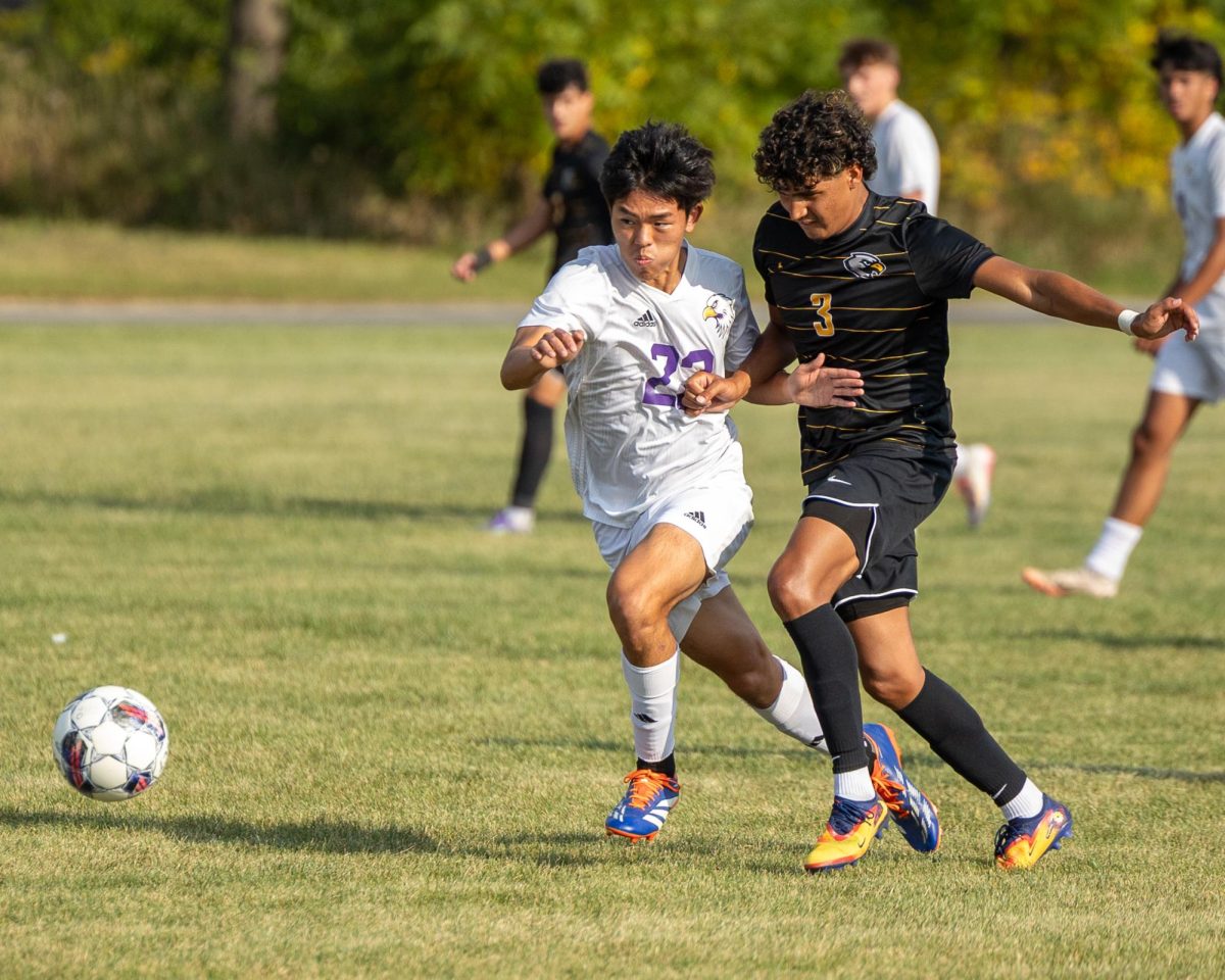 (from left) Yohann Cha (22) of IVCC and Adrian Hughes (3) of BHCC exchange shoves whilst pursuing the ball on Wednesday, Sept. 10, 2025 at Rotary Park in La Salle. (MaKade Rios for IV Leader)