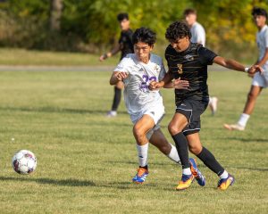 (from left) Yohann Cha (22) of IVCC and Adrian Hughes (3) of BHCC exchange shoves whilst pursuing the ball on Wednesday, Sept. 10, 2025 at Rotary Park in La Salle. (MaKade Rios for IV Leader)