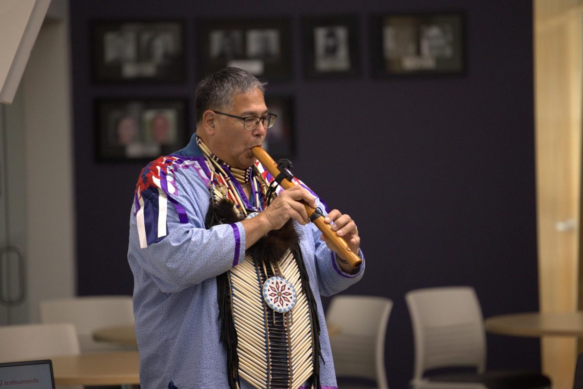 Gerald Savage demonstrates Native American Instruments used by members of his tribe to IVCC students.